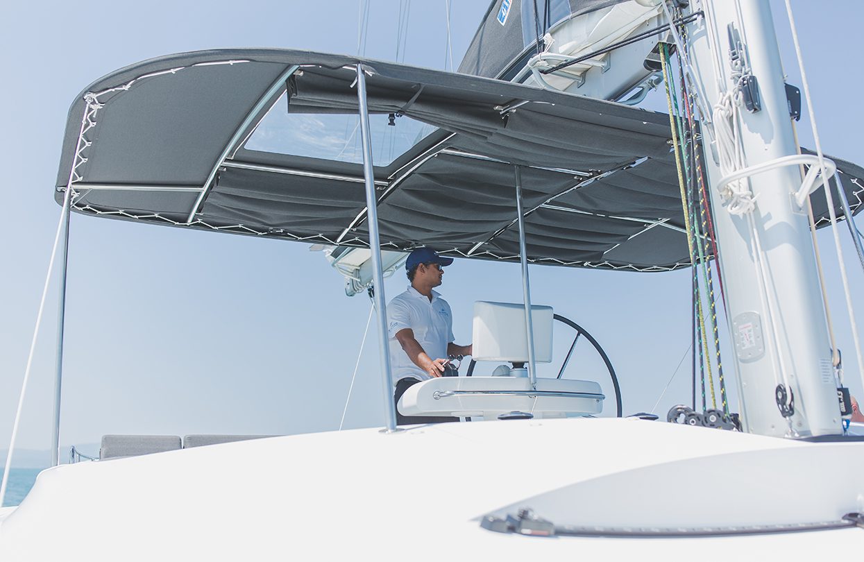 The Captain navigating the catamaran towards the Phang Nga Bay, Photo - Wan Tse, Simpson Yacht Charter